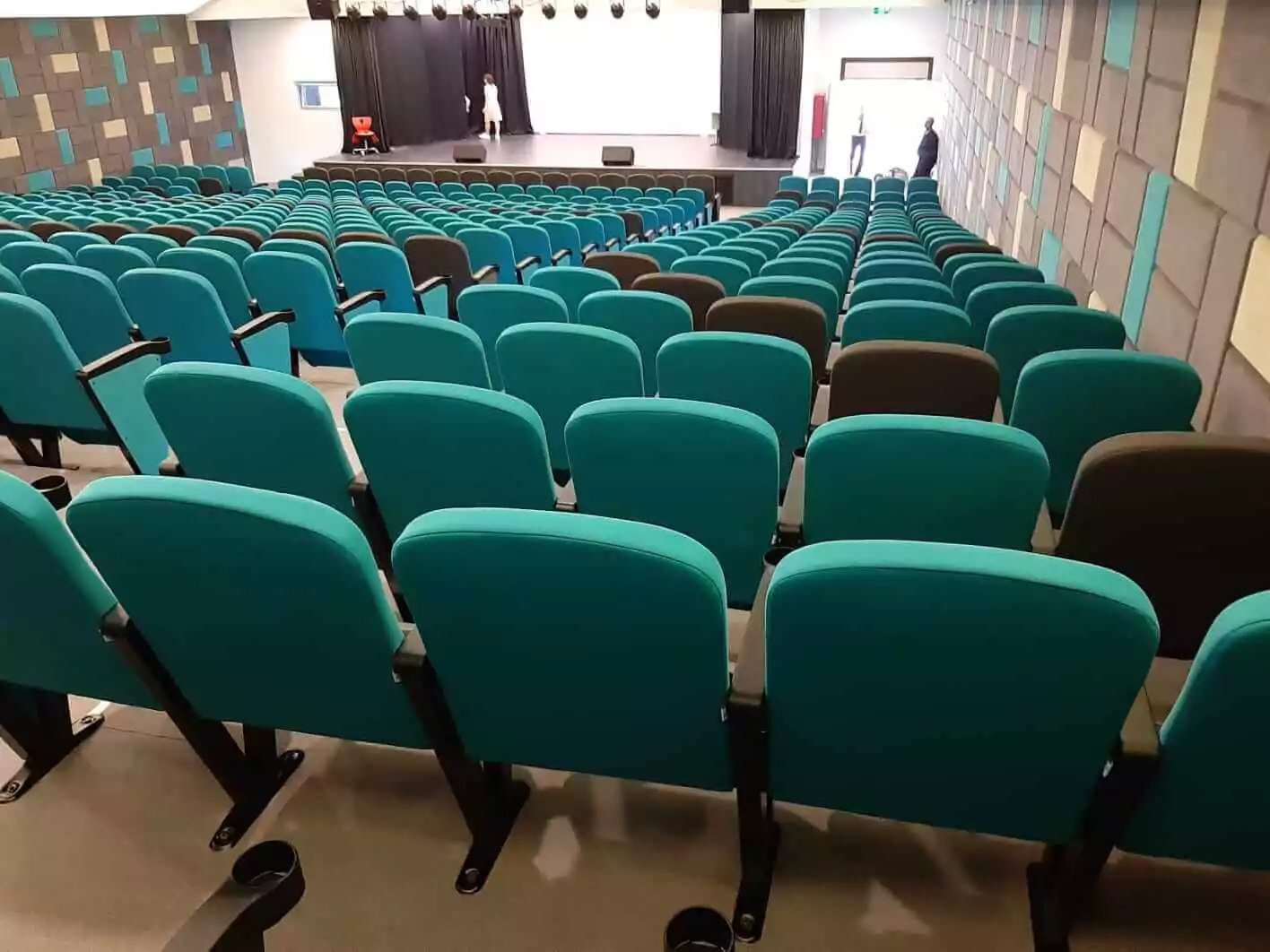 Our versatile auditorium seating adds both style and practicality to this corporate auditorium. Image